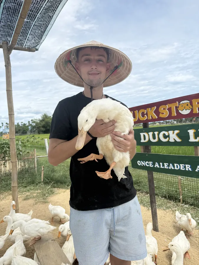 Holding a duck at the Duck Stop, Hoi An